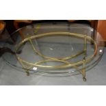 AN OVAL BRASS COFFEE TABLE WITH OVERSAILING PLATE GLASS TOP, C1980, 41CM H; 71 X 126CM Good