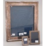 A GEORGE V SILVER PHOTOGRAPH FRAME, 33 X 28CM, BY A AND J ZIMMERMANN, BIRMINGHAM 1918 AND TWO