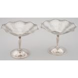 A PAIR OF EDWARD VII PIERCED SILVER SWEETMEAT STANDS, ON SLENDER STEM AND DOMED FOOT, 9CM H, BY E
