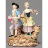 A MEISSEN GROUP OF A BOY AND GIRL WITH A FLASK AND A BASKET OF FLOWERS, ON ROCKY MOUND, WITH