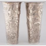 A PAIR OF SILVER REPOUSSE VASES OF TAPERED CYLINDRICAL SHAPE, FLARED AT THE RIM, BOLDLY DECORATED IN