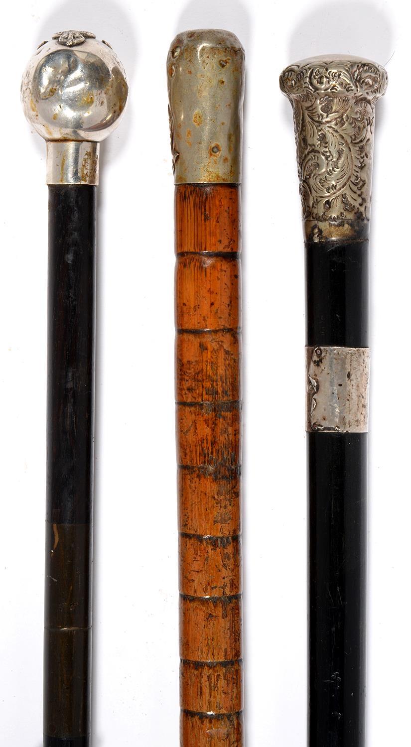 ONE BAMBOO AND TWO EBONY WALKING CANES, EACH WITH SILVER OR OTHER POMMEL, TWO MILITARY (ROYAL