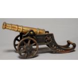 AN ORNAMENTAL BRASS MODEL CANNON ON IRON CARRIAGE, 20TH C, 46CM L Iron parts rusty