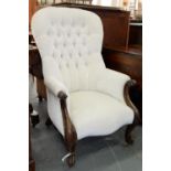 A VICTORIAN MAHOGANY ARMCHAIR, IN BUTTONED UPHOLSTERY, ON BRASS CASTORS Upholstery a little soiled /