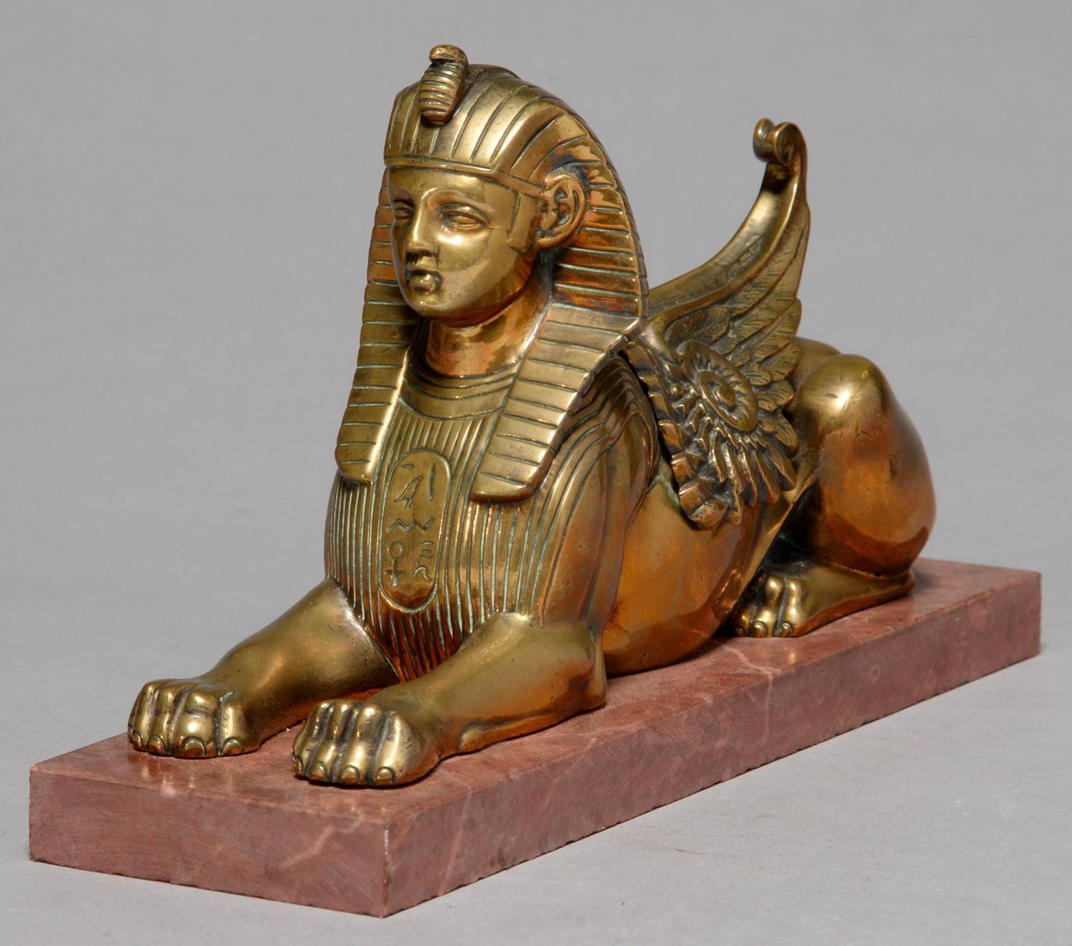 EGYPTOMANIA.  A BRONZE SCULPTURE OF THE SPHINX, C1870, ON ASSOICATED MARBLE BASE, 17.5CM L Old