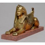 EGYPTOMANIA.  A BRONZE SCULPTURE OF THE SPHINX, C1870, ON ASSOICATED MARBLE BASE, 17.5CM L Old