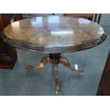 A VICTORIAN WALNUT AND INLAID LOO TABLE, C1870, WITH OVAL TOP ON POTTERY CASTORS, 68CM H; 87 X 115CM
