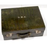 A GREEN STAINED CROCODILE HIDE DRESSING CASE, C1900, LINED IN GREEN SILK TRIMMED IN LEATHER, THE LID
