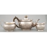AN EDWARDIAN  SILVER TEA SERVICE OF PROW FORM, CHASED WITH FLOWERS AND C SCROLLS, TEAPOT 13.5CM H,