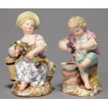 A PAIR OF MEISSEN FIGURES OF WINE MAKERS, C1870, THE BOY AND GIRL SEATED ON ROCKS HOLDING A VINE