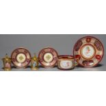 A PAIR OF VIENNA STYLE CLARET GROUND CABINET CUPS AND SAUCERS AND A LARGER SIMILAR CUP AND SAUCER,