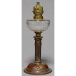 AN ART NOUVEAU OIL LAMP, C1910, WITH CUT GLASS FOUNT AND BRASS BURNER, THE DOMED FOOT EMBOSSED