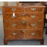 A WALNUT AND FEATHERBANDED CHEST OF DRAWERS, 19TH C, POSSIBLY INCORPORATING EARLIER VENEERS, THE