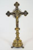 A large 19th century silver plate on brass Crucifix, the corpus backed by a sunburst and I.H.S.