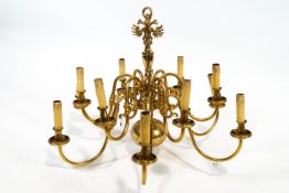 A brass Queen Anne style chandelier of traditional form with two rows of six 'S' scroll arms