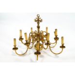 A brass Queen Anne style chandelier of traditional form with two rows of six 'S' scroll arms