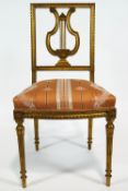 A French style gilt gesso salon chair with lyre back splat on a curved overstuffed cushion