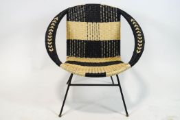 A 1960's black and white faux wicker chair on metal legs,