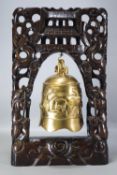 A brass Buddhist temple bell, of plain form, cast decorated with two dragons,