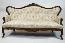 A Victorian mahogany show frame sofa, with arched button back, stuff over seat,