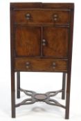 A George III mahogany wash stand, the top opening above one faux drawers,