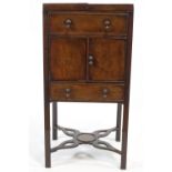 A George III mahogany wash stand, the top opening above one faux drawers,