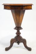 A Victorian walnut sewing table, with marquetry top on carved cabriole legs,