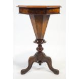 A Victorian walnut sewing table, with marquetry top on carved cabriole legs,