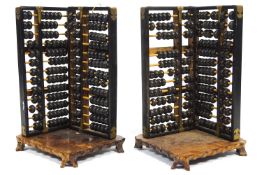 A pair of corner stands, each formed from two abacus,