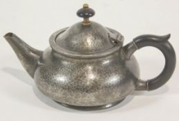 A pewter teapot with ebonised handle and knop, by Liberty & Co,