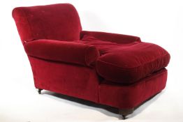 An armchair with long, deep seat, in the style of Howard and Sons,