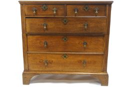 A small George III oak chest of two short and three long drawers, on bracket feet,