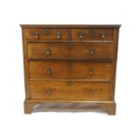 A small George III oak chest of two short and three long drawers, on bracket feet,