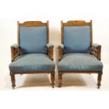 A pair of late Victorian mahogany show frame armchairs, on turned legs with casters,