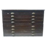 A pine plan chest with eight drawers and brass cup handles, stamped GRV A Cooper & Co,