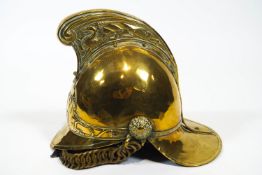 A New South Wales Fire Brigade brass helmet with leather work liner and chin strap, circa 1940,