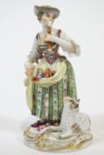 A porcelain Meissen style figure of a shepherdess playing a pipe, in polychrome clothing,