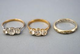 A collection of dress rings to include two three stone cubic zirconia rings