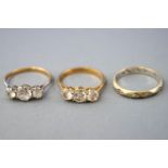 A collection of dress rings to include two three stone cubic zirconia rings