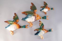 A set of four graduated Beswick pottery flying duck wall pockets, impressed marks,