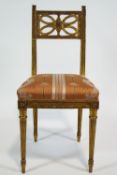 A French style gilt gesso salon chair with contrived quatrefoil back panel on an overstuffed seat