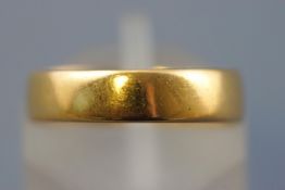 A yellow metal flat profile wedding ring, 4.2mm. Hallmarked 22ct gold, Birmingham, 1896. Size: K