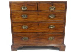 A George IV mahogany chest of of two short and three long graduated drawers on bracket feet,