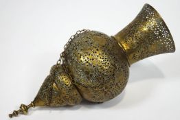 A Middle Eastern brass Islamic Mosque lamp, heavily pierced and engraved with decorative strap work,