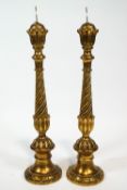 A pair of carved wood gilt Florentine style pricket candlesticks with baluster bases