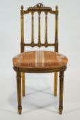 A Gilllows gilt gesso salon chair with carved cresting over a triple column splat