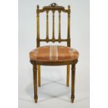 A Gilllows gilt gesso salon chair with carved cresting over a triple column splat