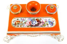 An early 19th century English porcelain desk set, of rectangular form, decorated in orange and gilt,