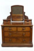 A mahogany dressing table with two long and two short drawers surmounted with a mirror,