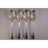 A group of four silver Old English pattern berry spoons,